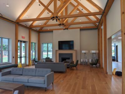 A living room with Big Weekend Oak beams and a fireplace.