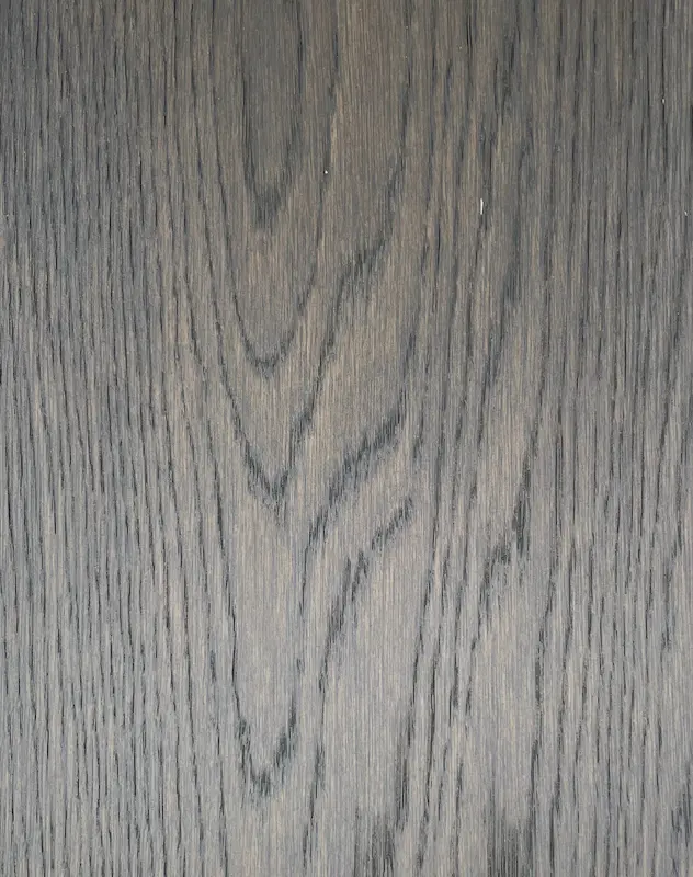 A close up view of an American Girl Oak wood surface.
