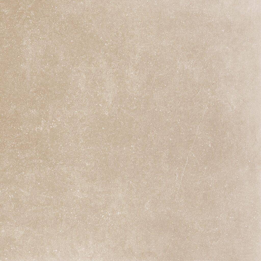 A beige tile background with some white spots