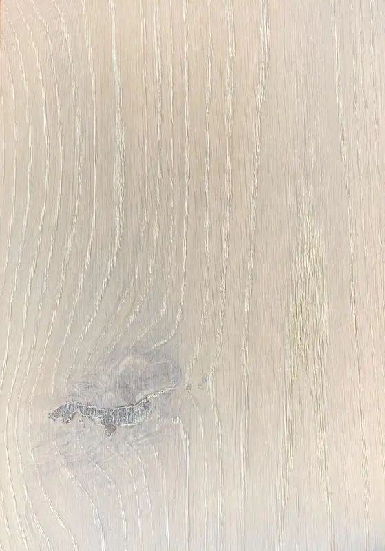 A close up of the wood grain on a white surface.