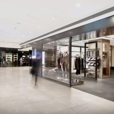 The interior of a clothing store with people walking in front of the 48000 FLOOR.