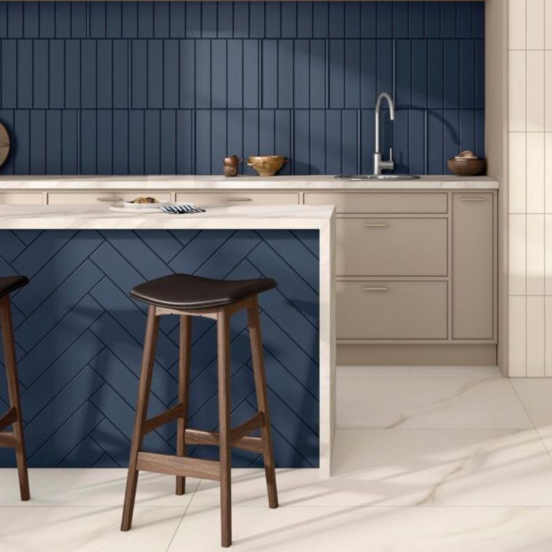 A kitchen with 33000 WALL tile and wooden stools.