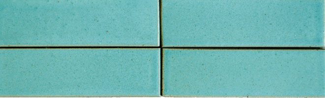 A close up of four square tiles in blue.