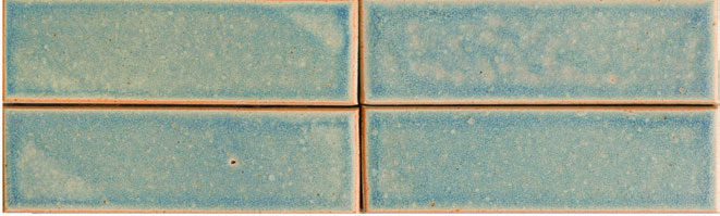 A close up of four blue tiles