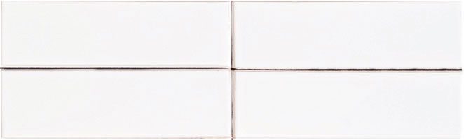 A white tile wall with four squares of each side.