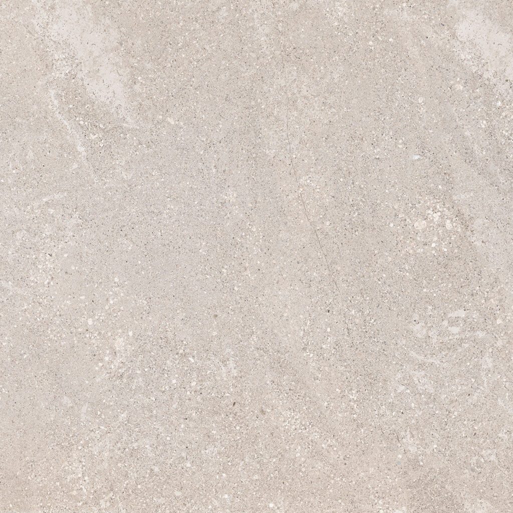 A close up of the surface of a white stone floor.