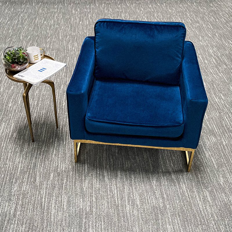 A blue RESOLUTE broadloom and a table in a room.