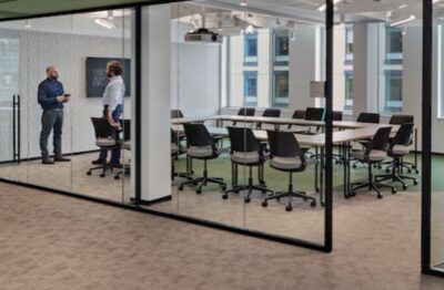 A Helios conference room with glass walls and chairs.