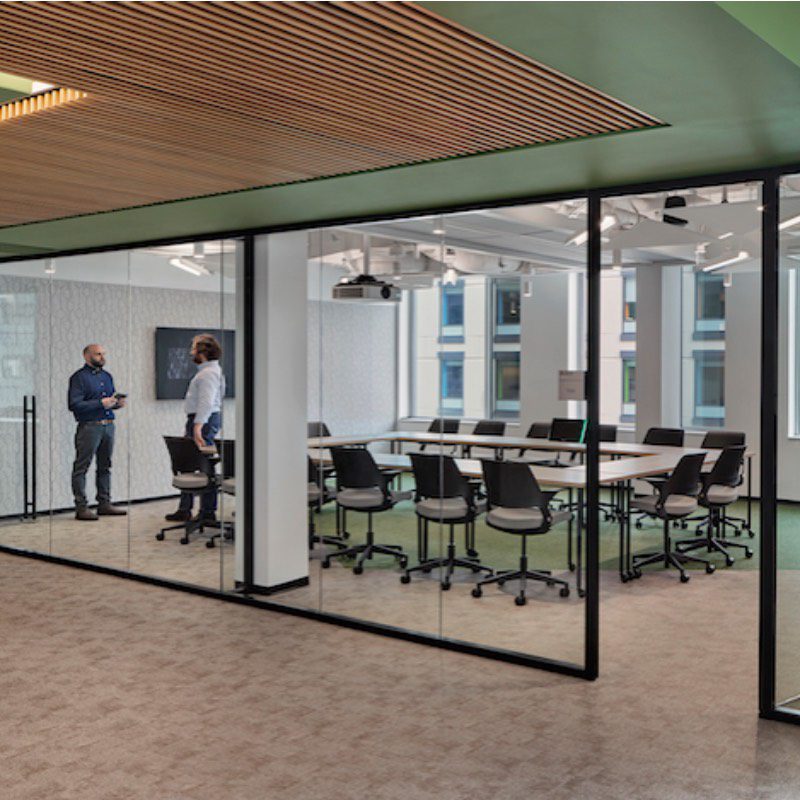 A Helios conference room with glass walls and chairs.