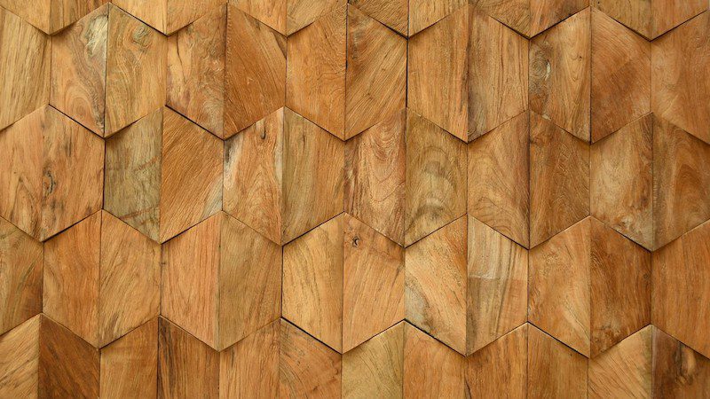 A wooden wall with a pattern of different shapes.