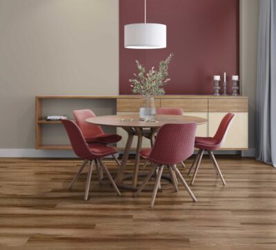 A dining room with Wellesley wood floors and red walls.