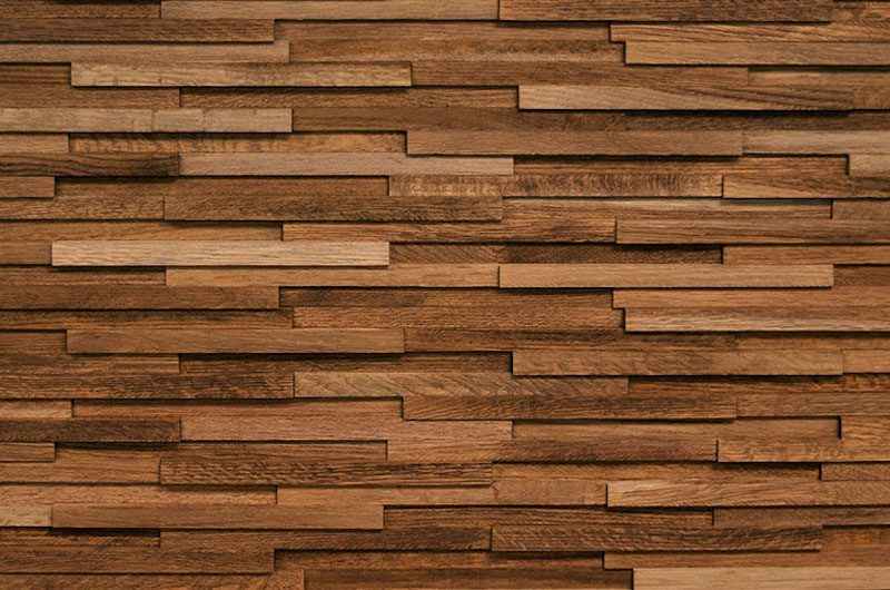 A wall made of wood blocks with different shades.