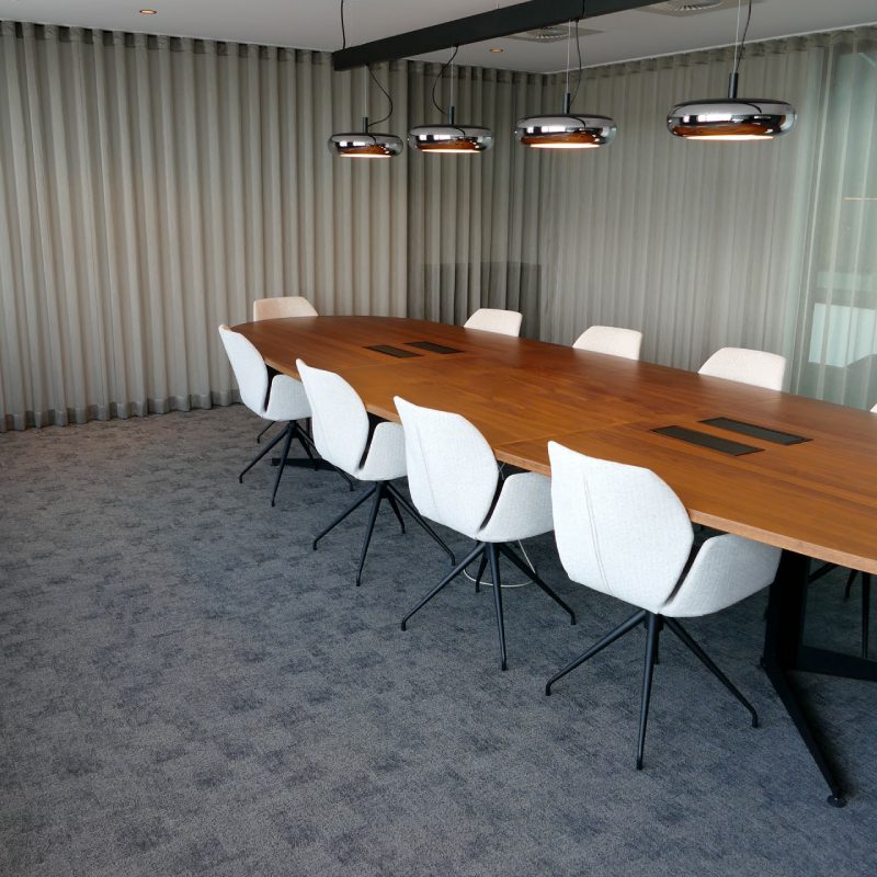 A conference room with a Halley table and chairs.