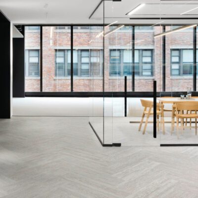 A modern office with a Maple wall and chairs.