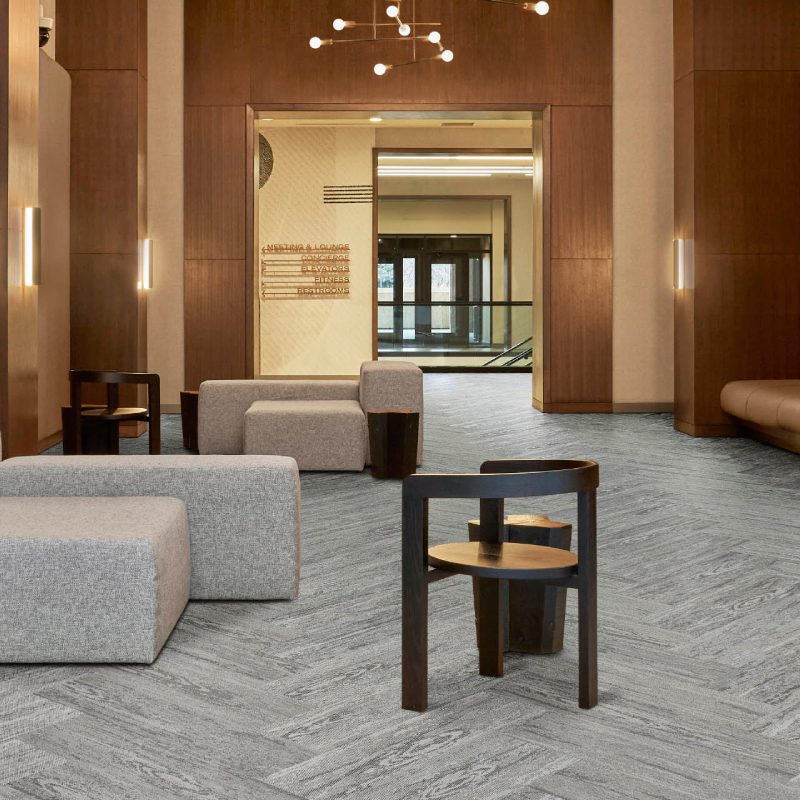 A lobby with Meranti floors and couches.