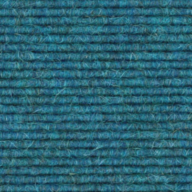 A close up image of a blue carpet.