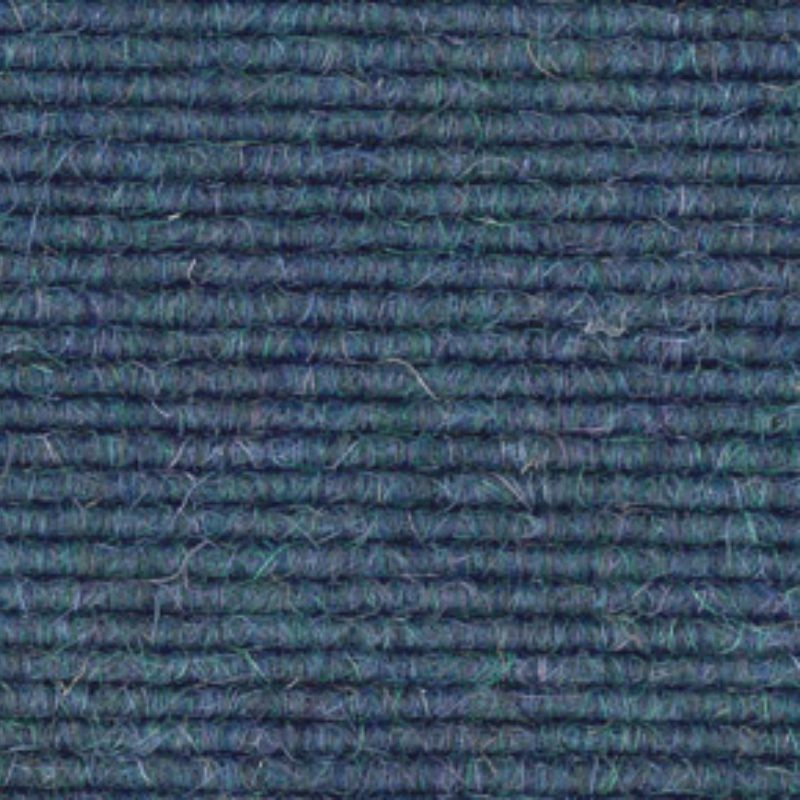 A close up image of a blue carpet.