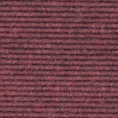 A close up image of a burgundy carpet.