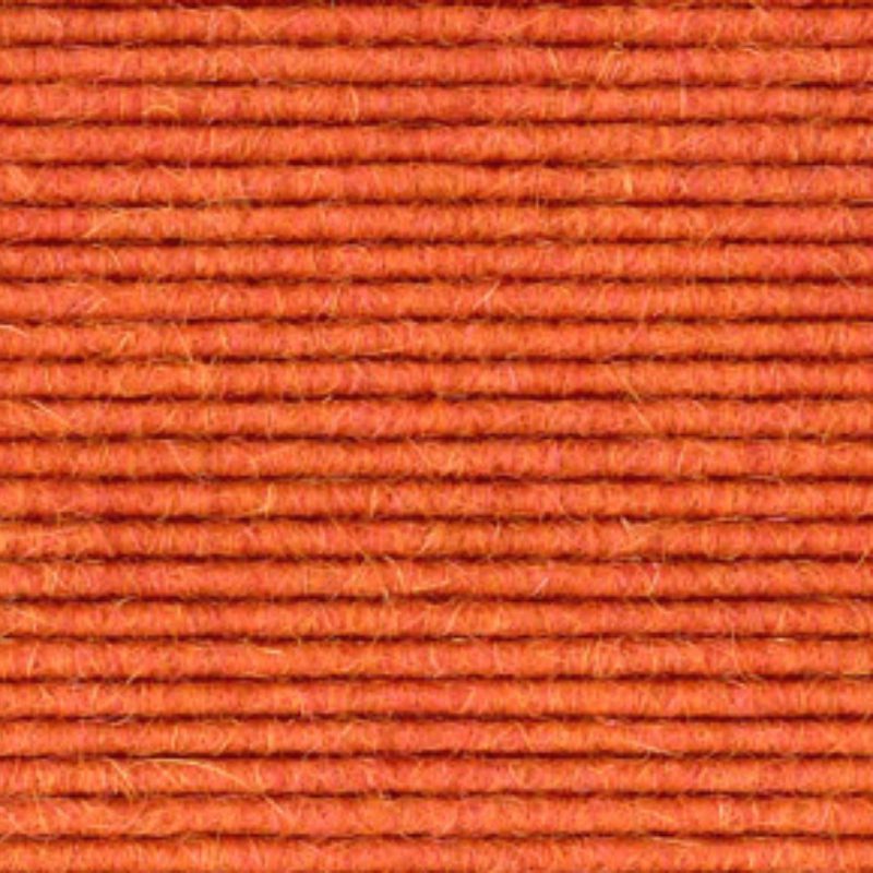 A close up image of an orange wool carpet.