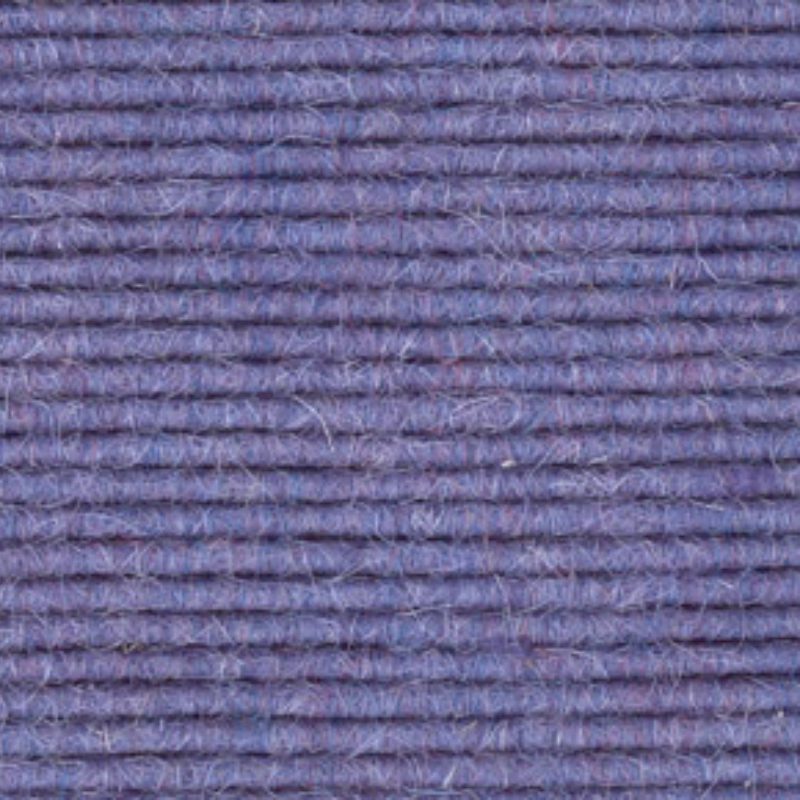 A close up image of a purple wool carpet.