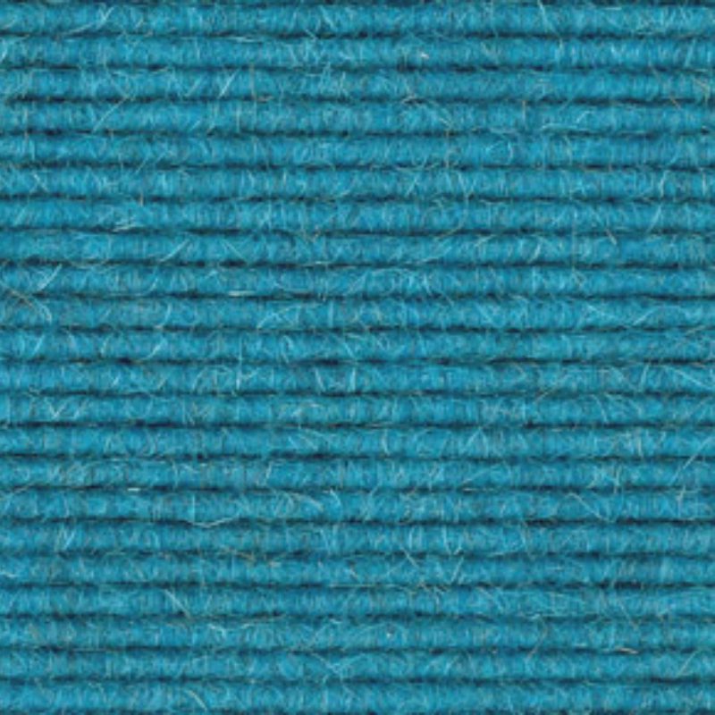 A close up image of a blue wool carpet.