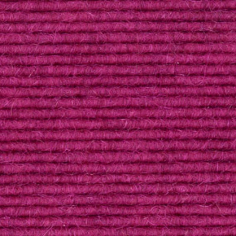 A close up image of a pink wool carpet.
