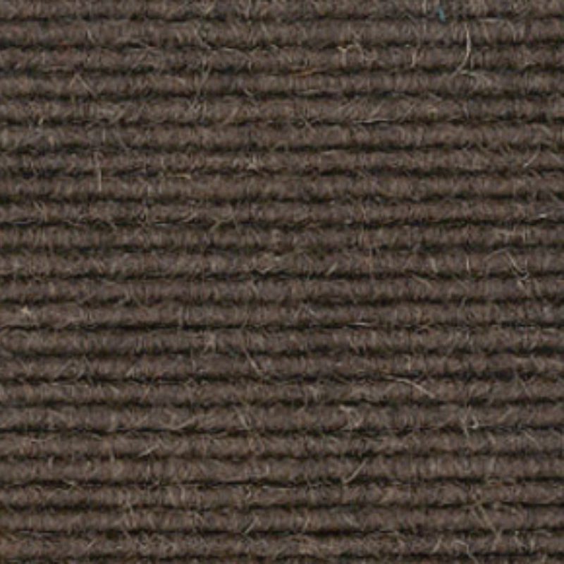 A close up image of a brown carpet.